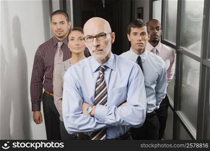 Portrait of business executives standing in a corridor