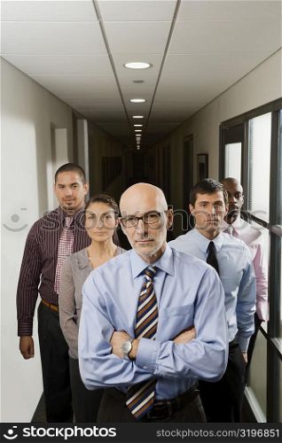 Portrait of business executives standing in a corridor