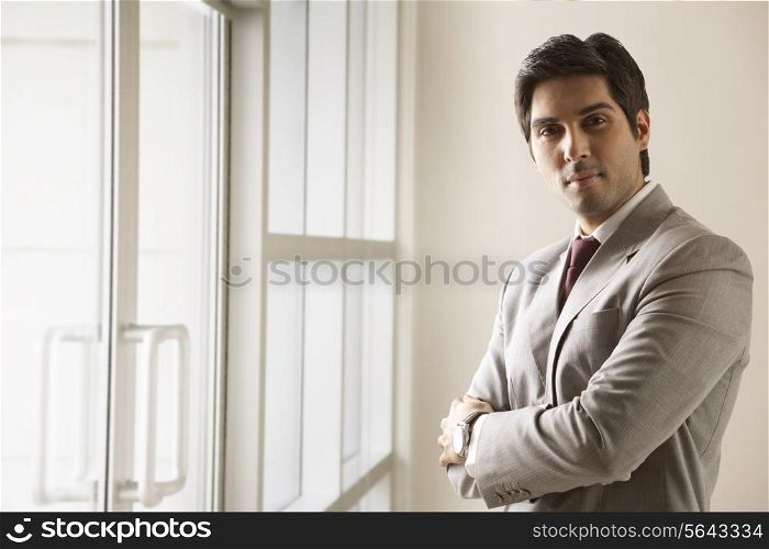 Portrait of business man standing with arms crossed