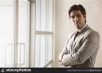 Portrait of business man standing with arms crossed