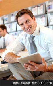 Portrait of business manager using electronic tablet