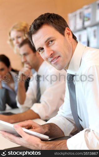 Portrait of business manager using electronic tablet