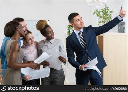 Portrait Of Business Team Capturing Selfie Together at Office