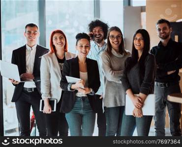 Portrait of Business team Standing in Modern Office on training in modern Office. Modern coworking startup open space office. High quality photo. Young Smiling Managers Standing in Modern Office. Training in Office. Modern Office Concept. Woman in White Shirt. Man in Black Suit.