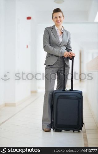Portrait of business woman in business trip with wheel bag