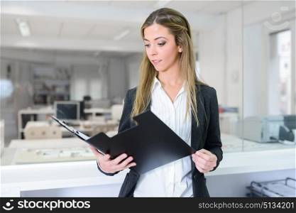 Portrait of business woman in modern glass interior