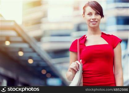 Portrait of business woman outside. Portrait of beautiful business woman in red dress