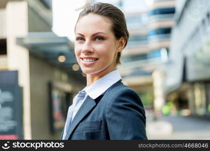 Portrait of business woman smiling outdoor. Portrait of young business woman outdoors