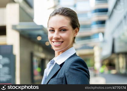 Portrait of business woman smiling outdoor. Portrait of young business woman outdoors