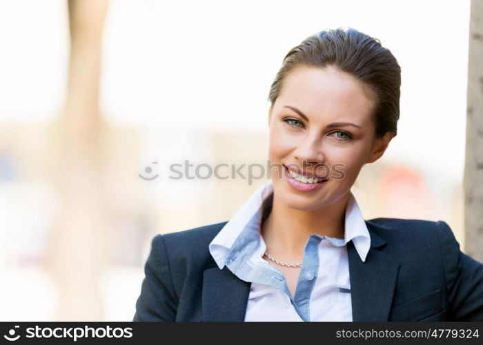 Portrait of business woman smiling outdoor. Portrait of young business woman outdoors