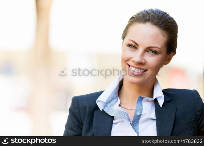 Portrait of business woman smiling outdoor. Portrait of young business woman outdoors