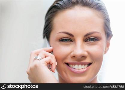 Portrait of business woman smiling outdoor. Portrait of young business woman with mobile phone outdoors