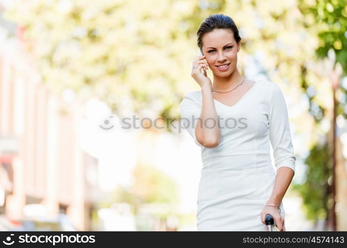 Portrait of business woman smiling outdoor. Portrait of young business woman with mobile phone outdoors