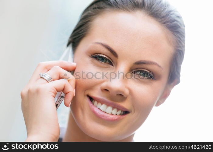 Portrait of business woman smiling outdoor. Portrait of young business woman with mobile phone outdoors