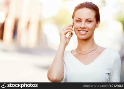 Portrait of business woman smiling outdoor. Portrait of young business woman with mobile phone outdoors