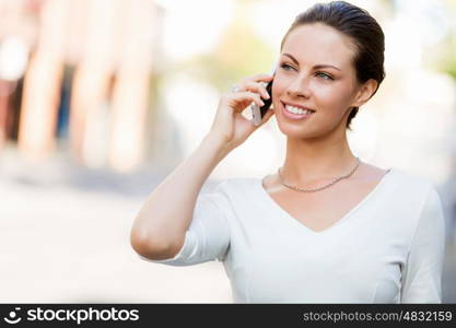 Portrait of business woman smiling outdoor. Portrait of young business woman with mobile phone outdoors