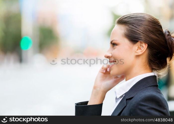 Portrait of business woman smiling outdoor. Portrait of young business woman with mobile phone outdoors