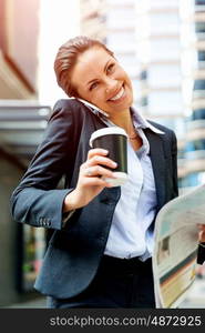 Portrait of business woman smiling outdoor. Portrait of young business woman with mobile phone outdoors