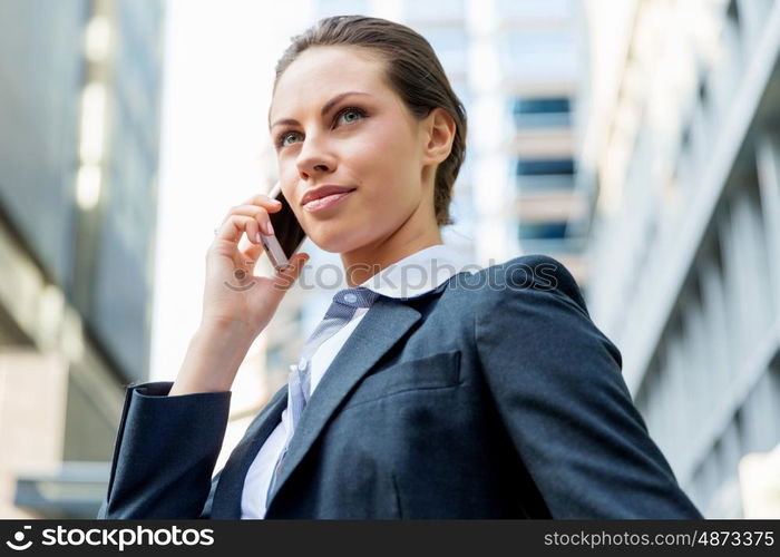 Portrait of business woman smiling outdoor. Portrait of young business woman with mobile phone outdoors