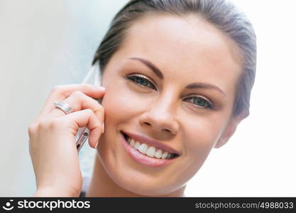 Portrait of business woman smiling outdoor. Portrait of young business woman with mobile phone outdoors