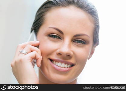 Portrait of business woman smiling outdoor. Portrait of young business woman with mobile phone outdoors