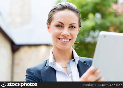 Portrait of business woman smiling outdoor. Portrait of young business woman with notebook outdoors