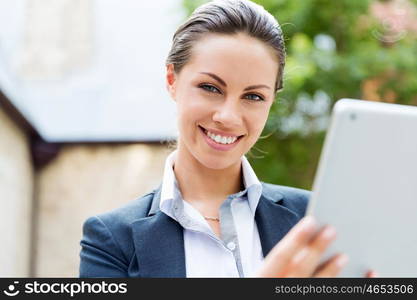 Portrait of business woman smiling outdoor. Portrait of young business woman with notebook outdoors