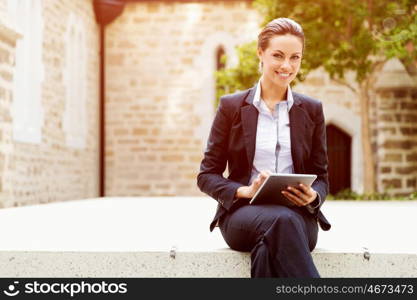 Portrait of business woman smiling outdoor. Portrait of young business woman with notebook outdoors