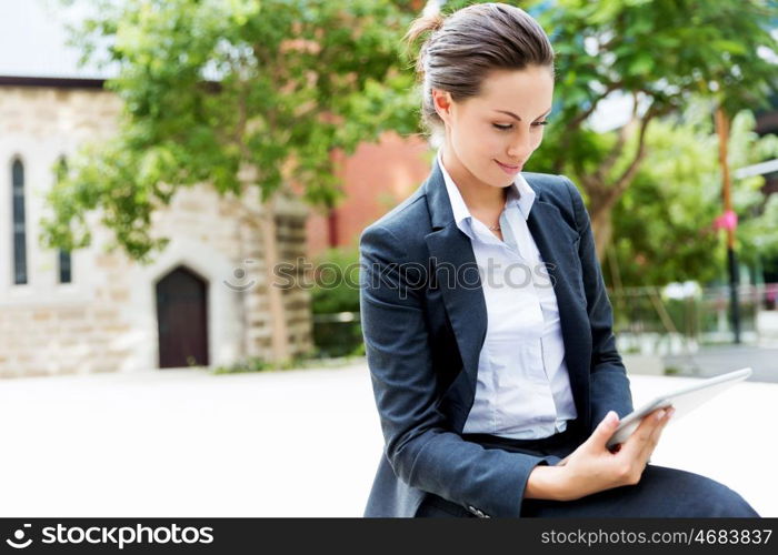 Portrait of business woman smiling outdoor. Portrait of young business woman with notebook outdoors