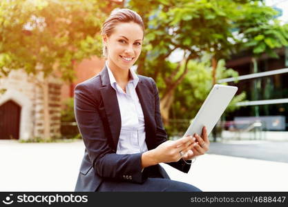 Portrait of business woman smiling outdoor. Portrait of young business woman with notebook outdoors