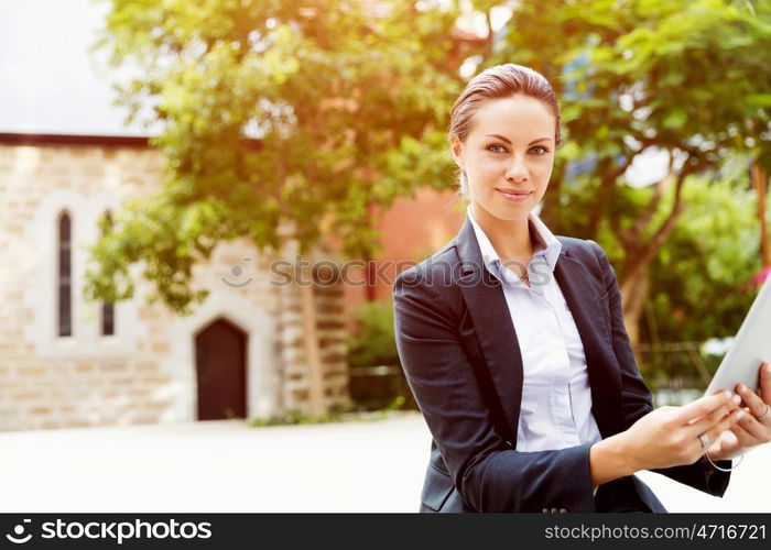 Portrait of business woman smiling outdoor. Portrait of young business woman with notebook outdoors