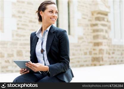 Portrait of business woman smiling outdoor. Portrait of young business woman with notebook outdoors