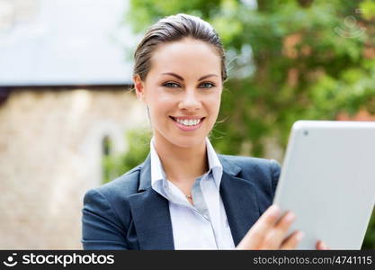 Portrait of business woman smiling outdoor. Portrait of young business woman with notebook outdoors