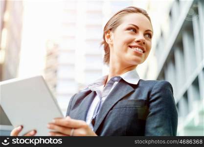 Portrait of business woman smiling outdoor. Portrait of young business woman with notepad outdoors