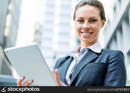 Portrait of business woman smiling outdoor. Portrait of young business woman with notepad outdoors