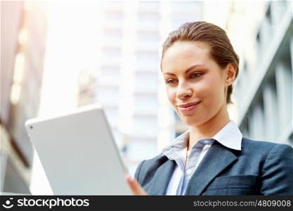 Portrait of business woman smiling outdoor. Portrait of young business woman with notepad outdoors
