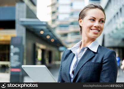 Portrait of business woman smiling outdoor. Portrait of young business woman with notepad outdoors