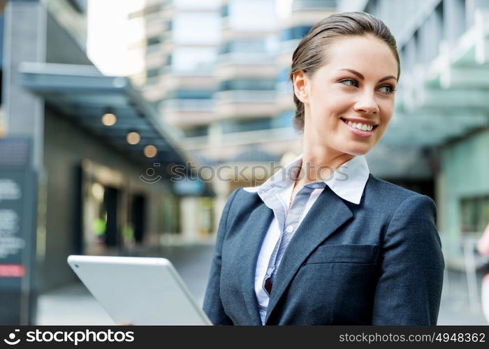 Portrait of business woman smiling outdoor. Portrait of young business woman with notepad outdoors