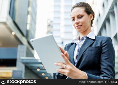 Portrait of business woman smiling outdoor. Portrait of young business woman with notepad outdoors