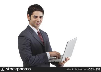 Portrait of businessman doing business on laptop