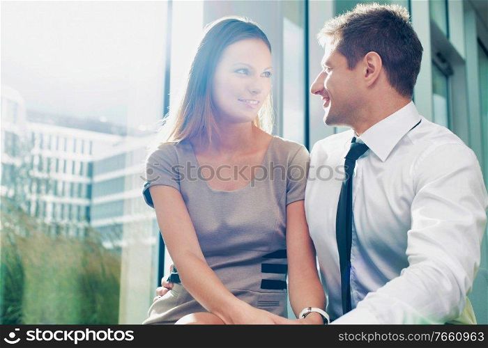 Portrait of businessman giving partner love and affection in hotel lobby