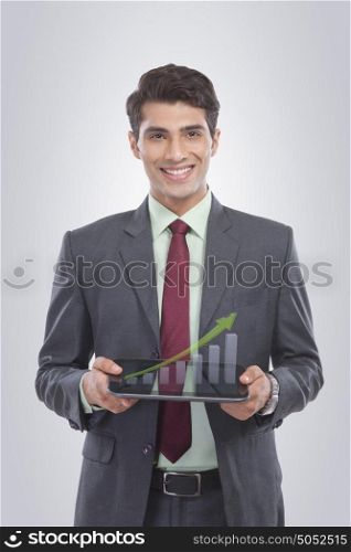 Portrait of businessman holding a digital tablet