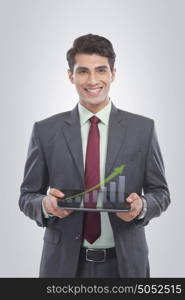 Portrait of businessman holding a digital tablet