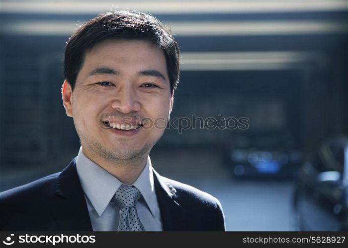Portrait of businessman in a parking garage