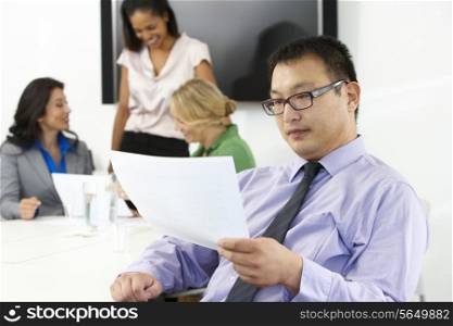 Portrait Of Businessman In Boardroom With Colleagues