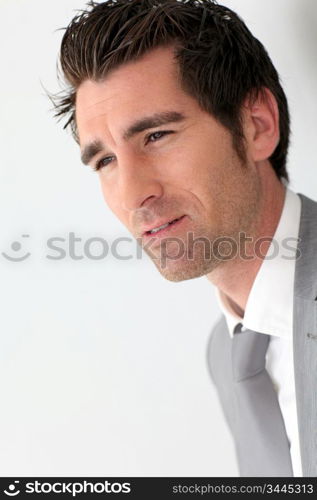 Portrait of businessman on grey background