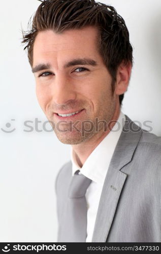 Portrait of businessman on grey background