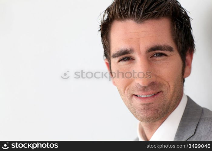 Portrait of businessman on grey background