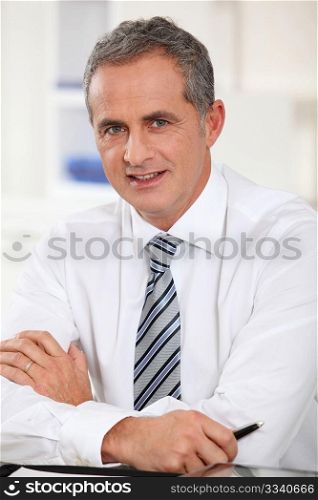 Portrait of businessman sitting at his desk