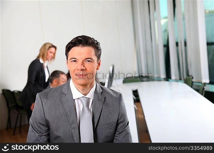 Portrait of businessman sitting in meeting room